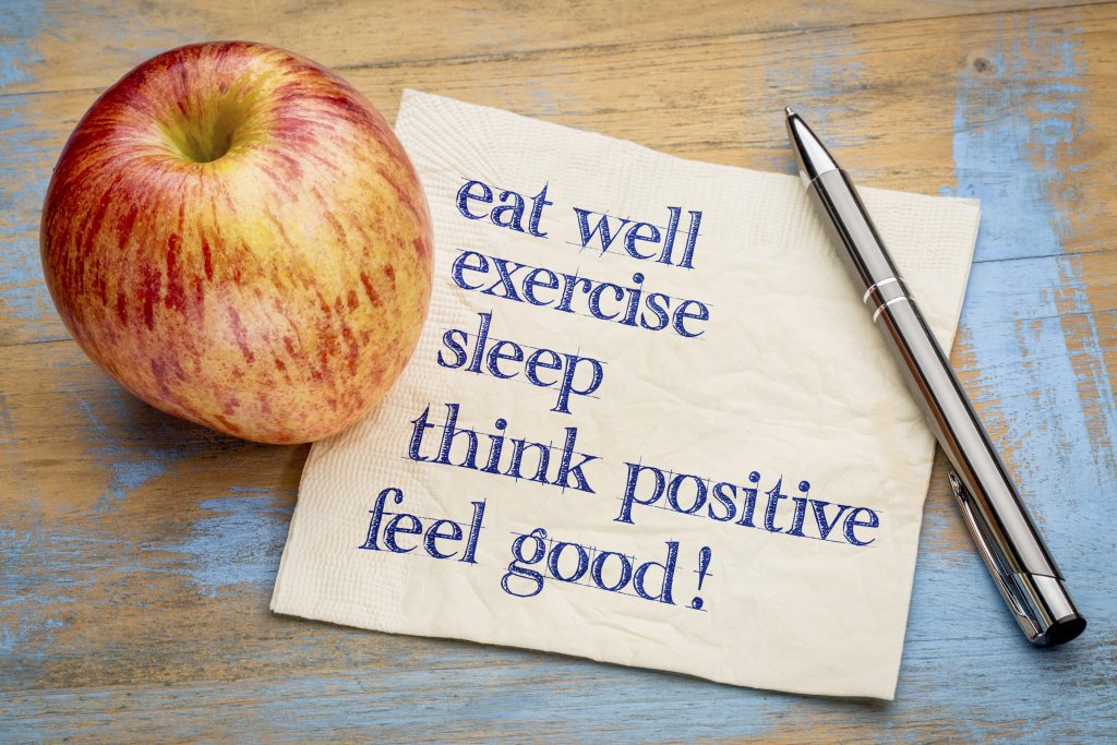 Picture of apple and sheet highlighting wellness principals